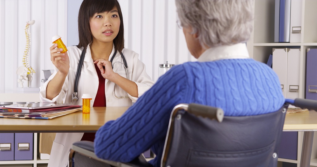 Asian doctor talking about medication to elderly patient
