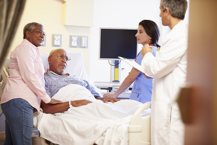 Man and woman in hospital talking to doctor and nurse