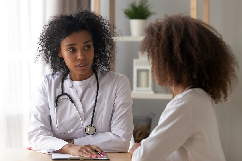 Female doctor consulting young patient