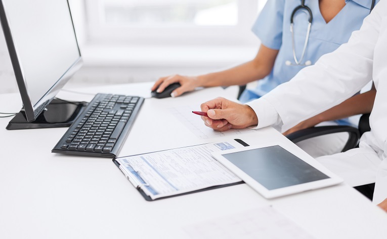 Group of doctors looking at tablet