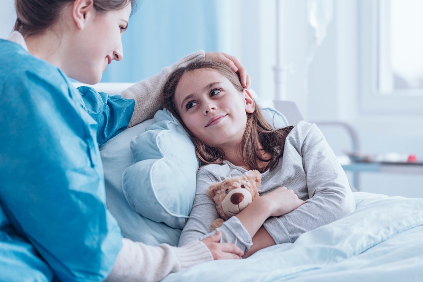 Smiling caregiver visiting sick child