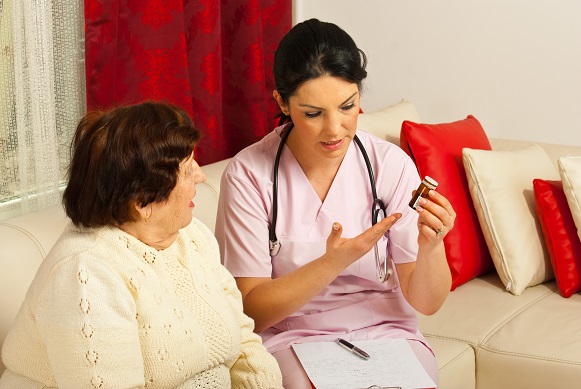 Doctor giving meds to elderly woman